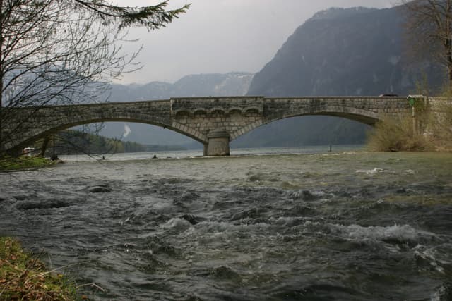 The Sava Bohinjka outflow from Lake Bohinj at Ribčev Laz, clear water between rocky banks.