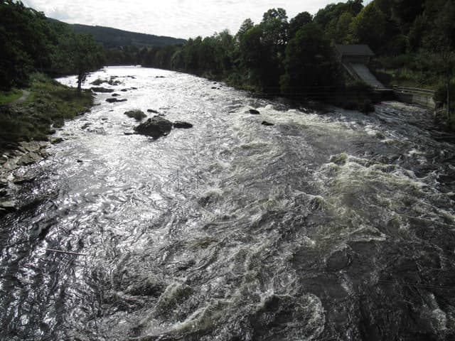 The River Tay rapids at Grandtully, fast broken white water over bedrock in a gorge section.