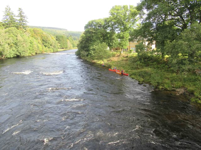 The River Tay at Grandtully on a September day, the wide clear river with wooded hillsides beyond.
