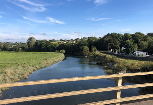 A wide view of the River Towy flowing through the Llangunnor reach at Carmarthen.