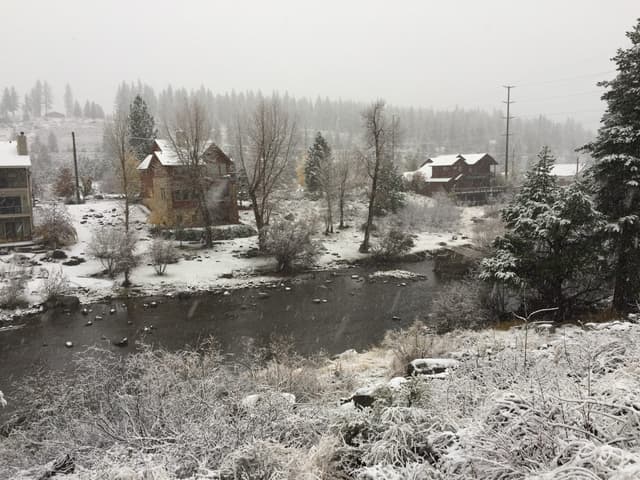 View across the Truckee River during a snowstorm at Truckee River Regional Park, Truckee, California.
