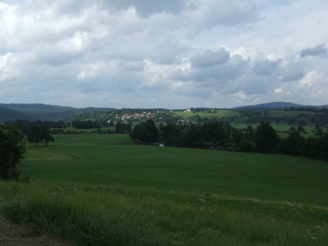 The Unica flowing past the village of Jakovica, Municipality of Logatec, with meadows on the bank.