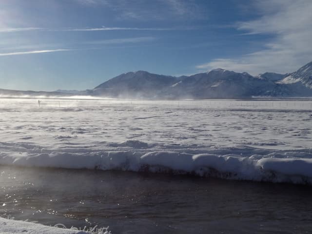 The Upper Owens River in winter with sunlight reflections on the water, Long Valley, Mono County.