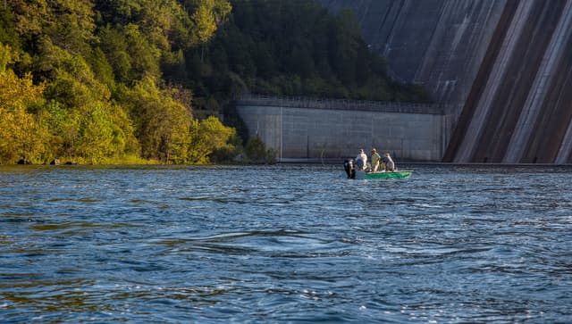 Group fishing in boat near Bull Shoals Dam on White River