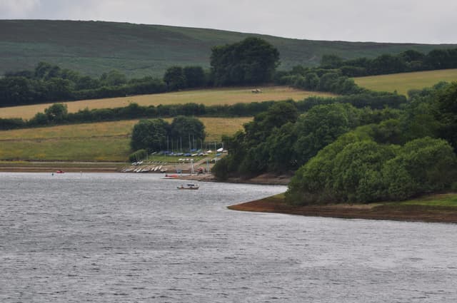 Wimbleball Lake viewed from Berrow Bridge looking back toward the sailing club on the wooded shoreline.