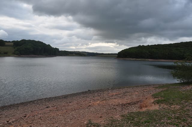 Broad northward view across Wimbleball Lake with Bessom Bridge at the far end of the reservoir.