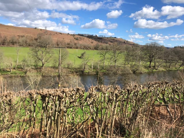 The River Wye flowing through open moorland pasture north of Erwood, the river the primary subject.